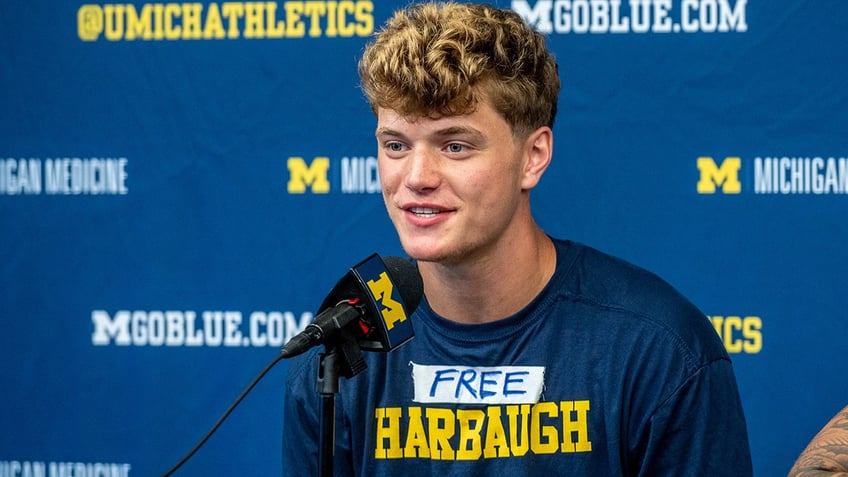 michigans jj mccarthy backs suspended jim harbaugh with t shirt message