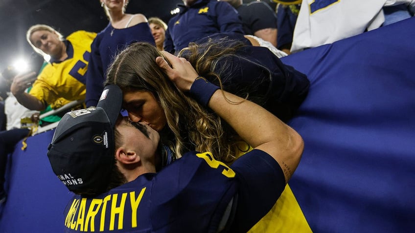 JJ McCarthy kisses his girlfriend