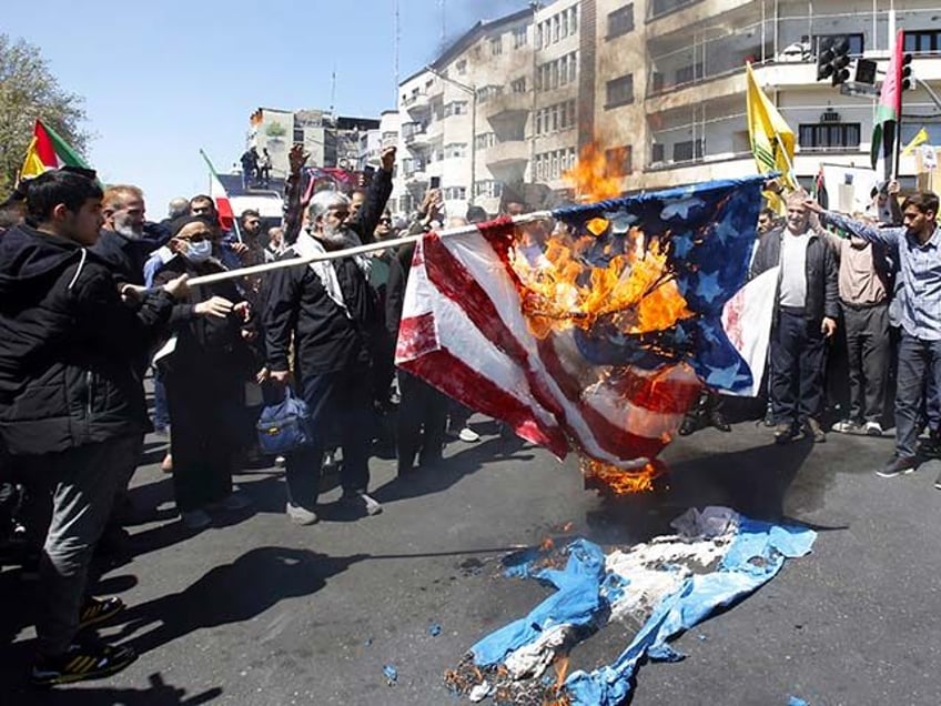 Iranian demonstrators burn representations of the U.S. and Israeli flags during an annual