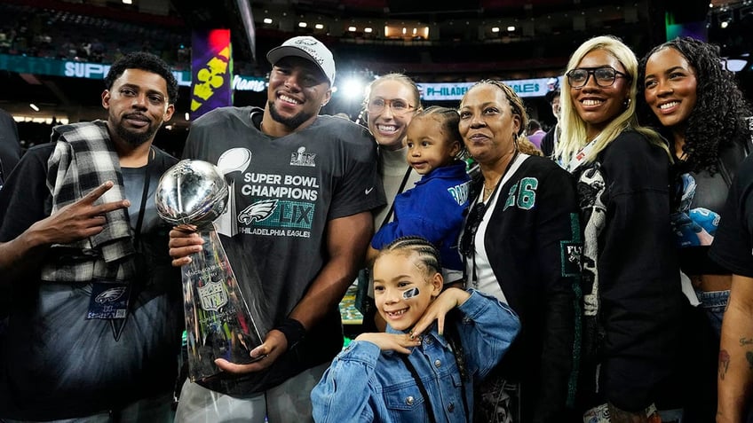 Saquon Barkley holds the Vince Lombardi Trophy