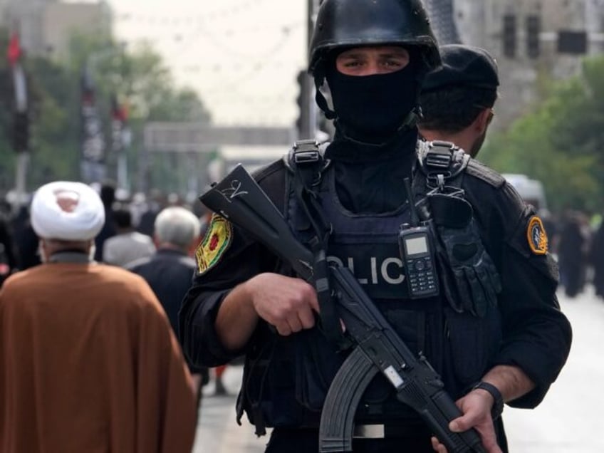 An Iranian police officer stands guard during the funeral ceremony of Hamas leader Ismail