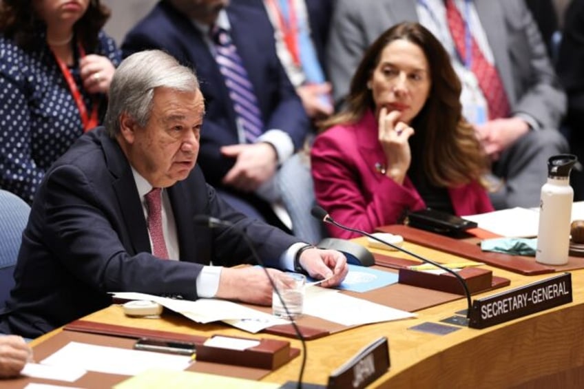 United Nations Secretary-General Antonio Guterres (L) delivers opening remarks during a UN