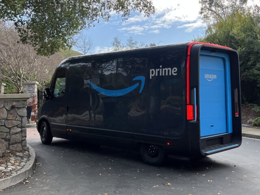 An Amazon electric delivery truck, developed by electric vehicle maker Rivian, makes deliv