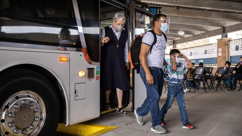 Sister Norma Pimentel helping migrants off a bus