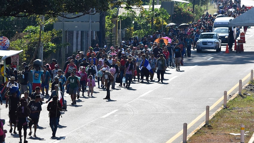 Migrants walking near a road