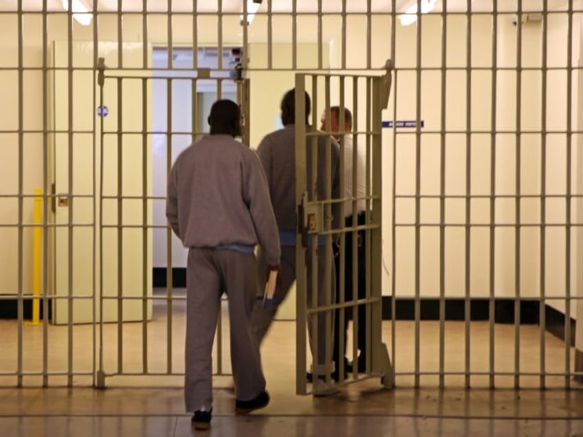 Two prisoners leave the F wing through a security gate inside Wandsworth prison. HMP Wands