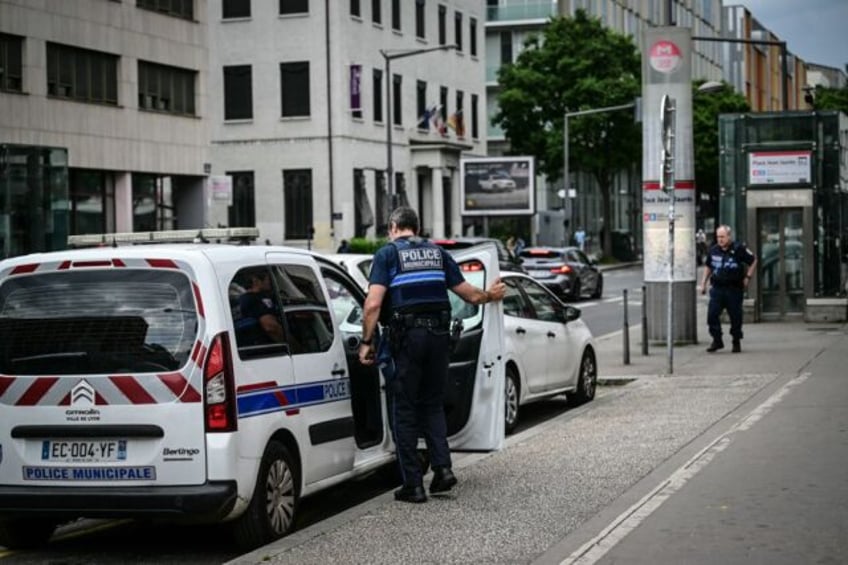 Municipale police patrol outside Place Jean Jaures metro station (R) where three people we