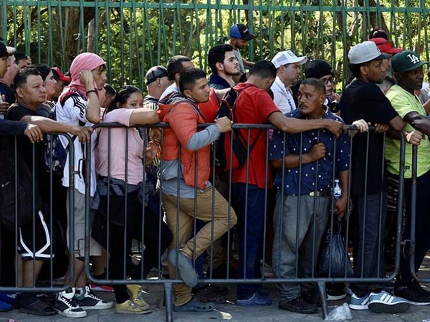Migrants wait to be processed by the Mexican refugee commission, following the cancellatio