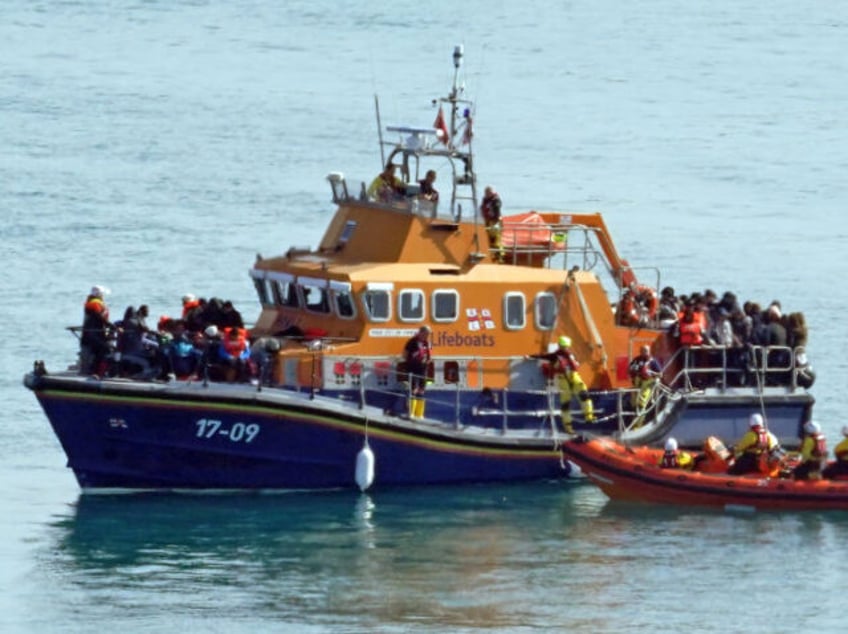 A group of people thought to be migrants are brought in to Dover, Kent, onboard the RNLI D