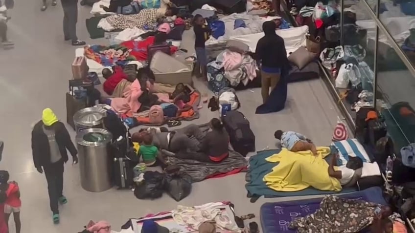 Migrants sleeping on Logan Airport floor