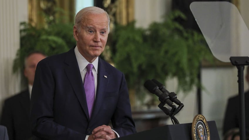 Joe Biden in coat and light purple tie