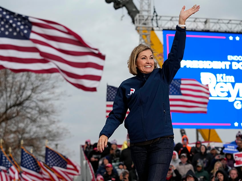 Iowa Gov. Kim Reynolds waves to supporters before speaking at a rally for former President