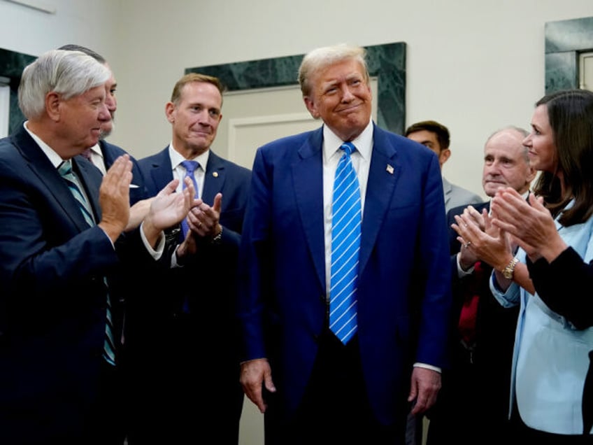 Former US President Donald Trump, center, following a meeting with Senate Republicans at t