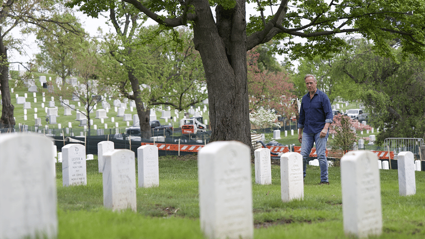 Mike Rowe walking through memorial