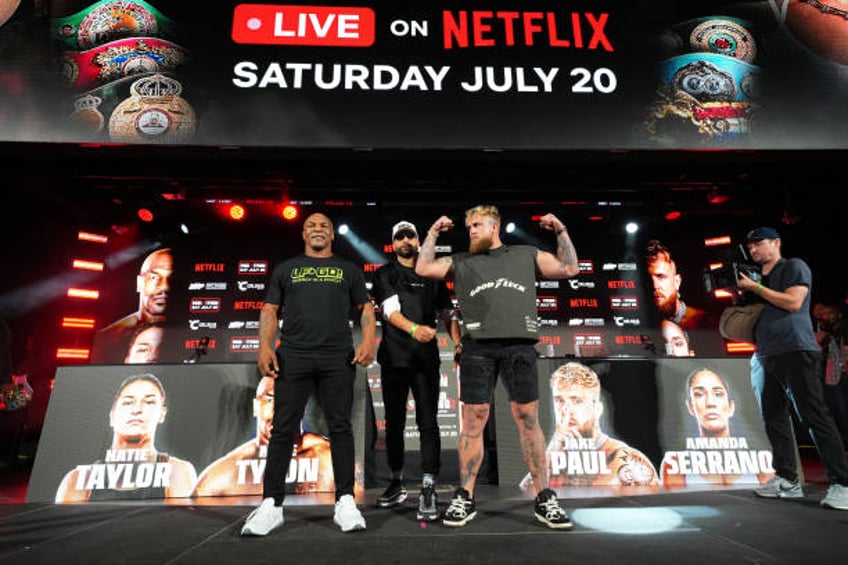 Mike Tyson, Nakisa Bidarian and Jake Paul pose onstage during the Jake Paul vs. Mike Tyson Boxing match Arlington press conference at Texas Live! on...