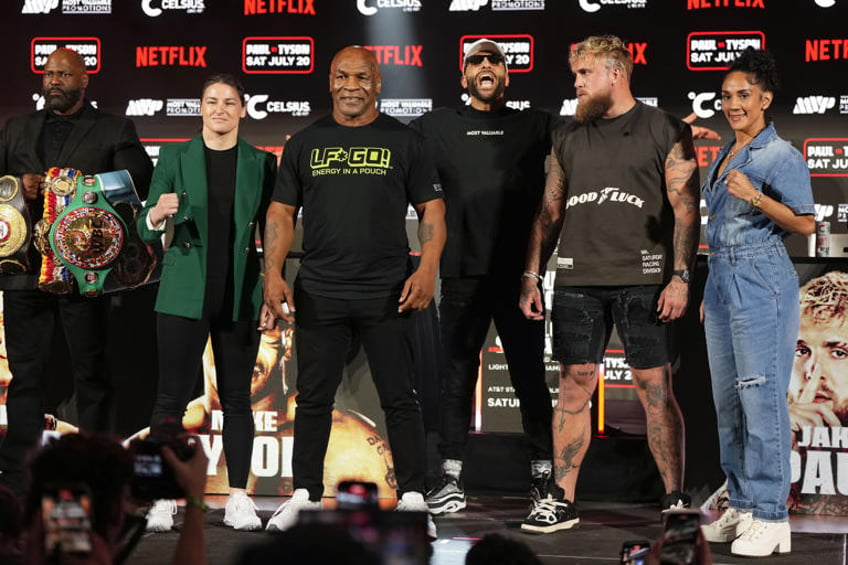 Katie Taylor, Mike Tyson, Jake Paul and Amanda Serrano, from left, pose for photos during a news conference promoting their upcoming boxing bouts, Thursday, May 16, 2024, in Arlington, Texas. The fights are scheduled for July 20. (AP Photo/Sam Hodde)