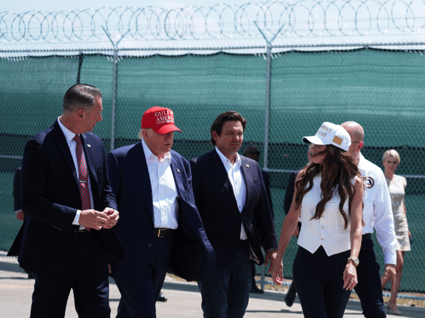 President Donald Trump, Gov. Ron DeSantis, R-Fla., and Homeland Security Secretary Kristi Noem, and others, tour "Alligator Alcatraz," a new migrant detention facility at Dade-Collier Training and Transition facility, Tuesday, July 1, 2025, in Ochopee, Fla. (AP Photo/Evan Vucci)