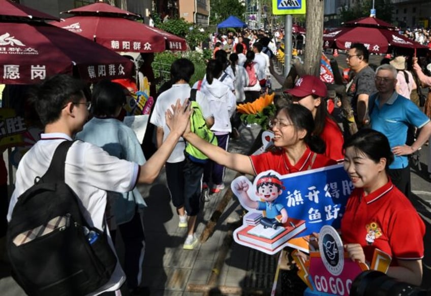 While teachers and staff offered students their support, holding up signs of encouragement