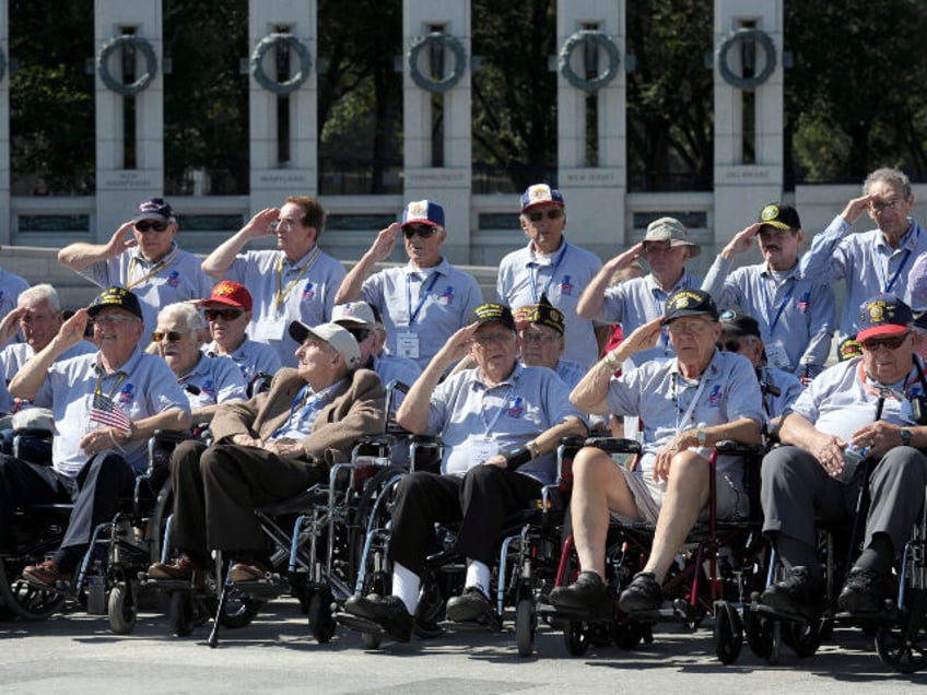 World War II veterans from the Chicago-area salute as they visit the World War II Memorial