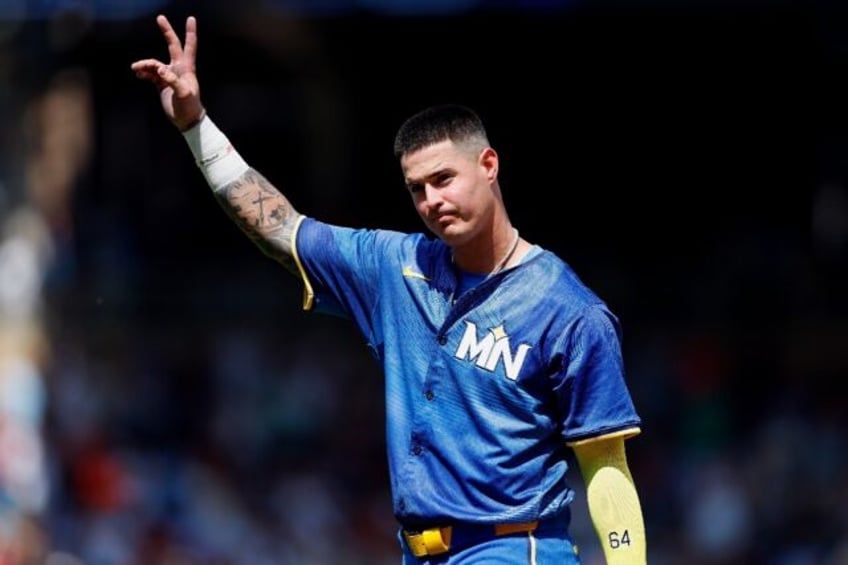 Jose Miranda of the Minnesota Twins acknowledges the cheers of fans after the end of his r