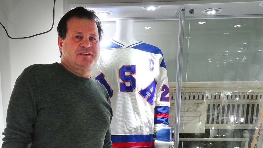 Mike Eruzione poses in front of his jersey