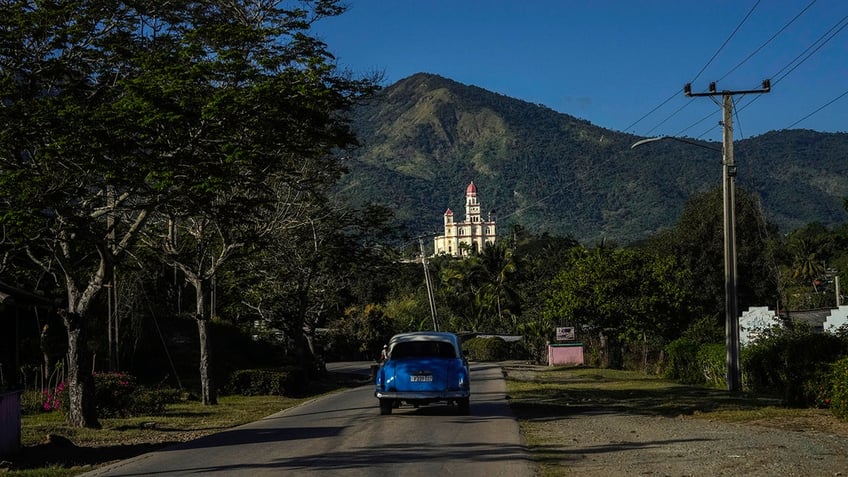 car on road in front of shrine