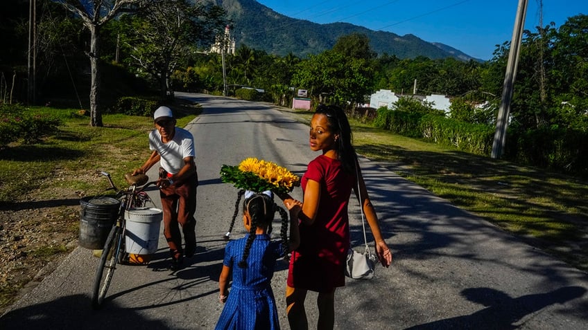 Mother and daughter walking with flowers