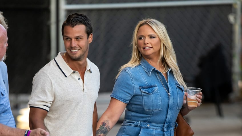 Brendan McLoughlin and Miranda Lambert hold hands while walking