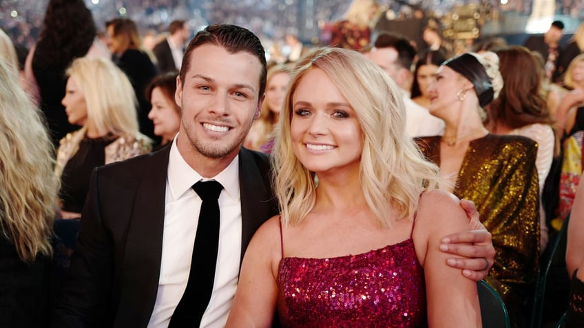 Brendan McLoughlin and Miranda Lambert sit in a crowd together