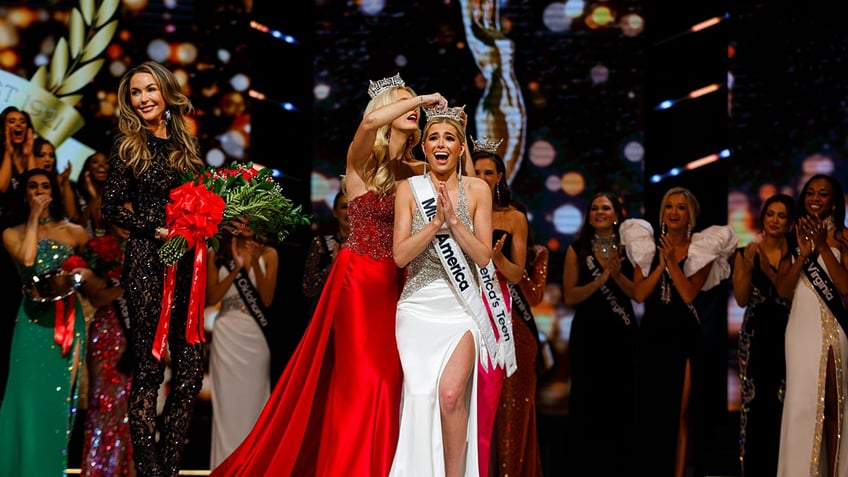 Abbie Stockard getting crowned and looking surprised on stage.