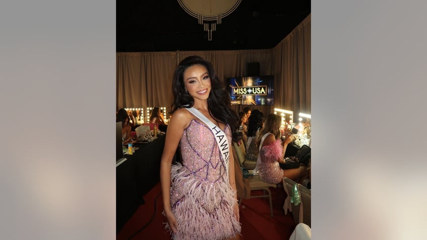 miss usa samantha gankiewicz smiling while in a dressing room