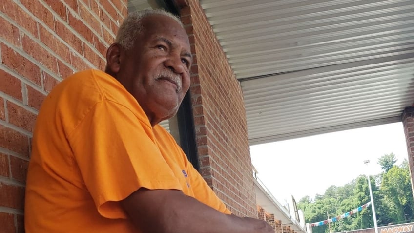 Kenneth Turner sitting outside his antique store