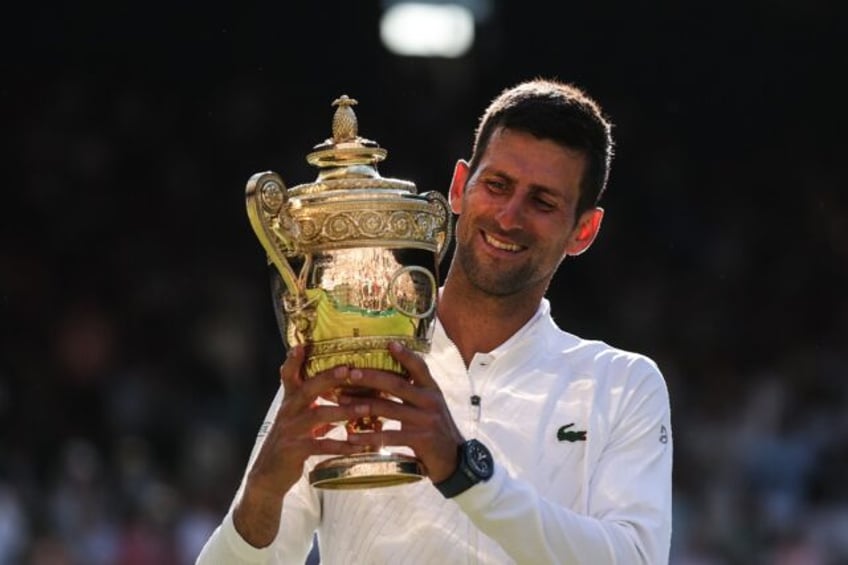 Seven-up: Novak Djokovic poses with his trophy after defeating Nick Kyrgios in the 2022 fi