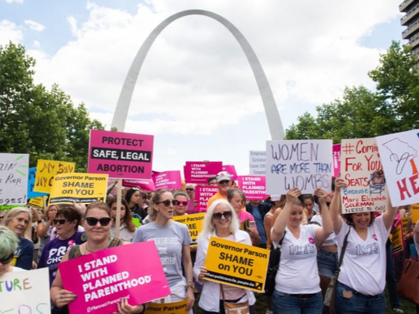 Thousands of demonstrators march in support of Planned Parenthood and pro-choice as they p