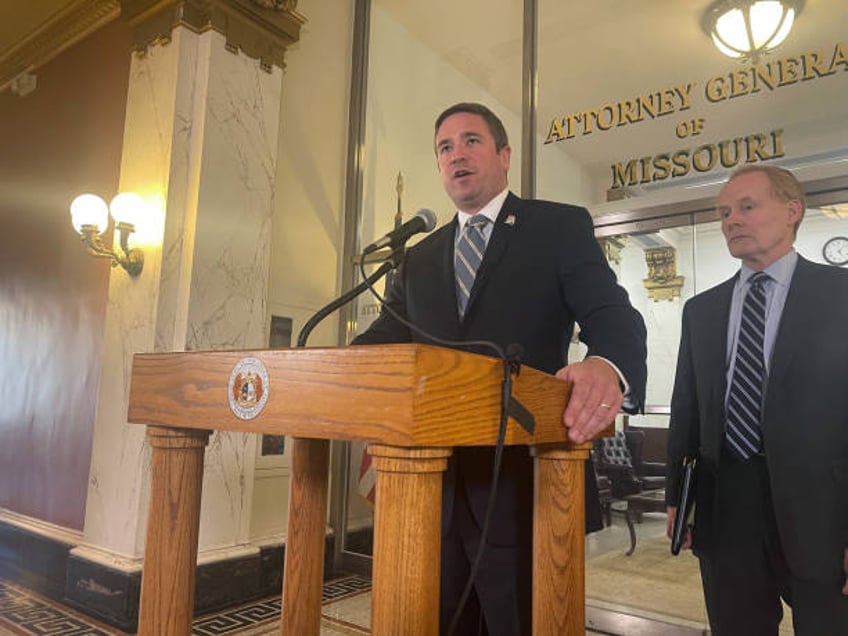 Missouri Attorney General Andrew Bailey, left, speaks to reporters during a press conference on May 3, 2023.