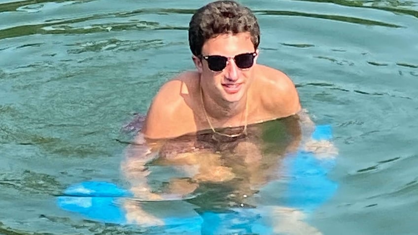 Daniel Santulli in a pool with sunglasses