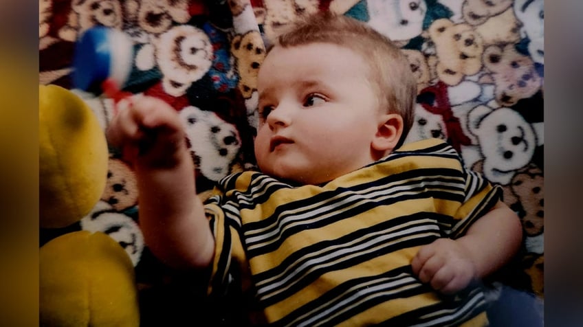 A baby wearing a stripped hat