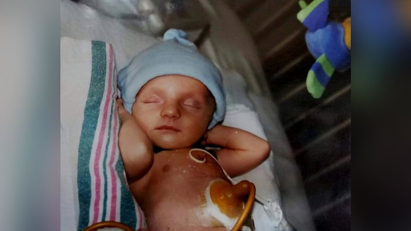 A baby wearing a blue hat