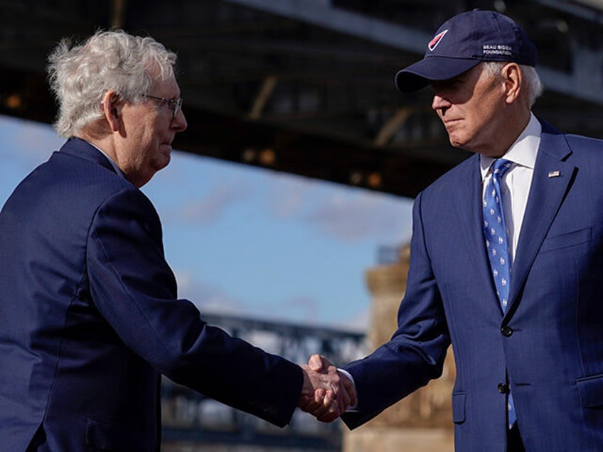 President Joe Biden shakes hands with Senate Minority Leader Mitch McConnell of Ky., after