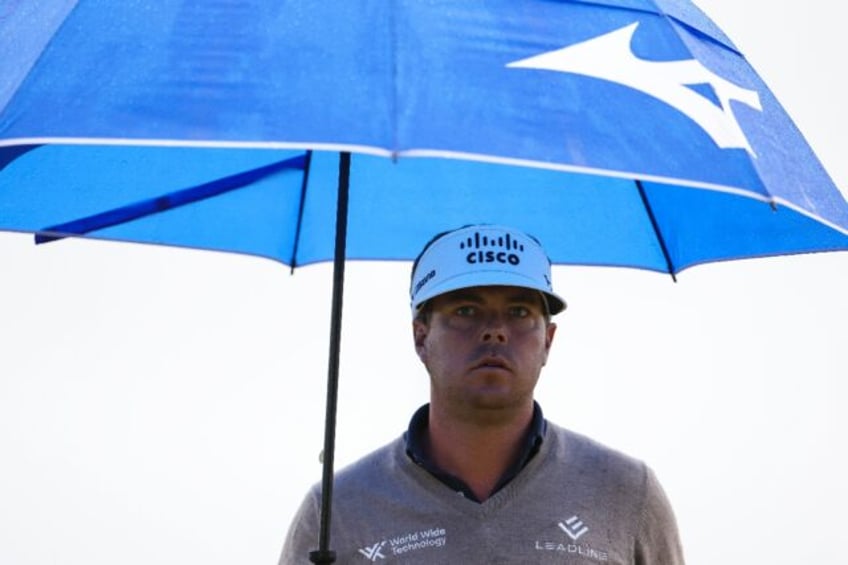 American Keith Mitchell fired a 67 in rainy conditions to keep the lead after the second r