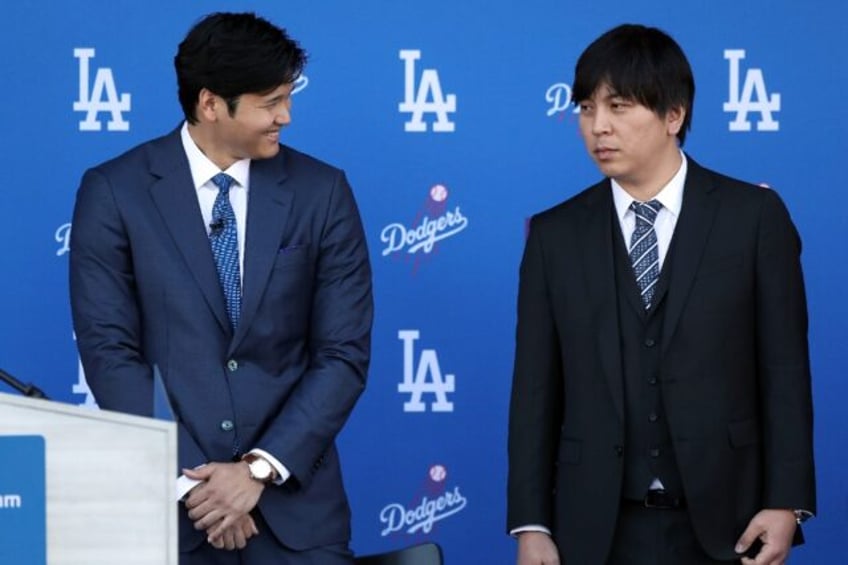 Shohei Ohtani, left, speaks with interpreter Ippei Mizuhara prior to being introduced by t