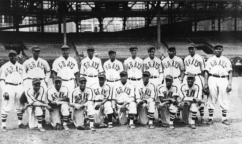 The Homestead Grays Negro League baseball club pose for a team shot in their home park, Forbes Field in Pittsburgh, in 1942. Hall of Fame members on...