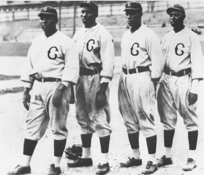 Oscar Charleston, Josh Gibson, Ted Paige and Judy Johnson posing for a group photo during a Negro League baseball game, San Francisco, California,...