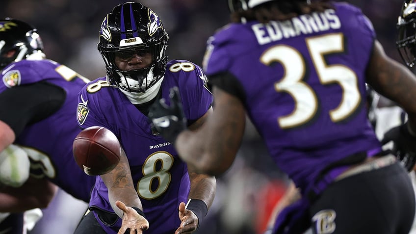 Lamar Jackson tosses the ball