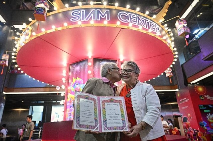 Kan Kerdmeemool (L) and Pakotchakorn Wongsupa (R), together for 30 years, pose for photos