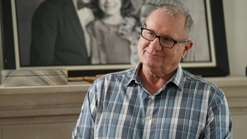 Ed ONeill on the set of Modern Family as Jay Pritchett in a blue checkered shirt