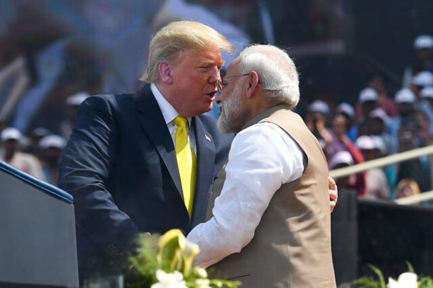 US President Donald Trump shakes hands with India's Prime Minister Narendra Modi during a