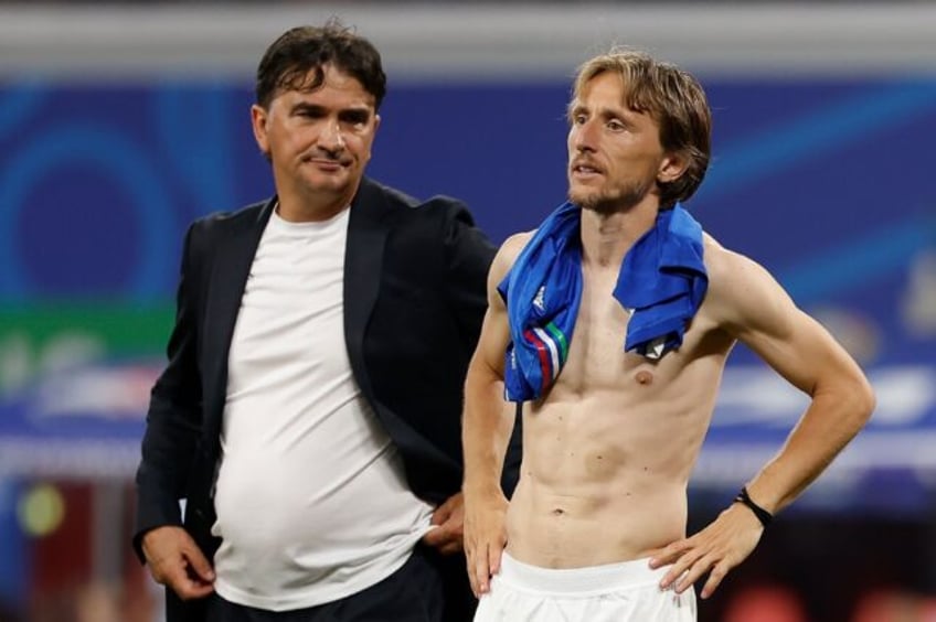Luka Modric (R) and Croatia coach Zlatko Dalic (L) look on after Italy scored a last-gasp