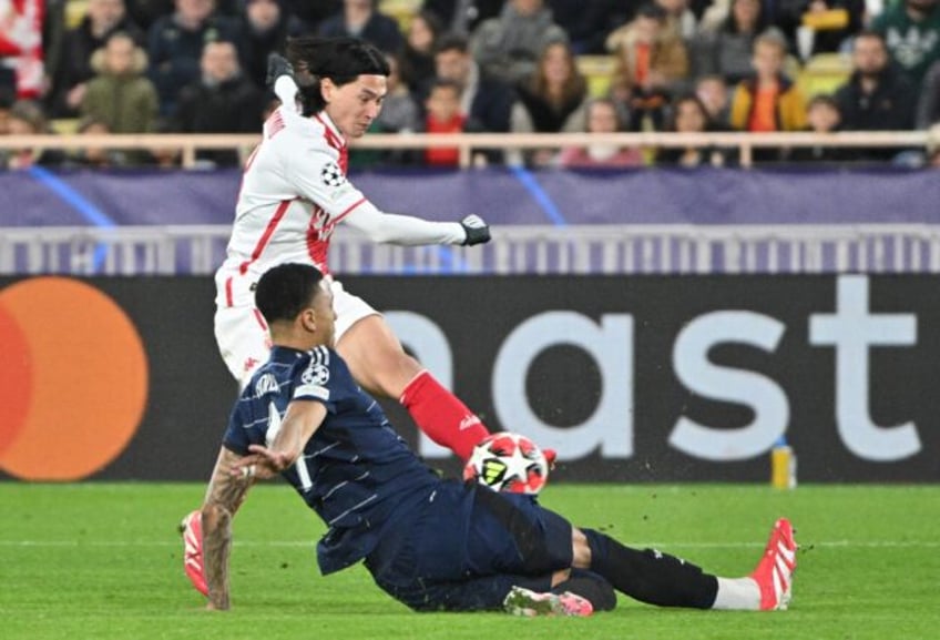 Takumi Minamino (in white) has his shot blocked by Ezri Konsa as Monaco beat Aston Villa i