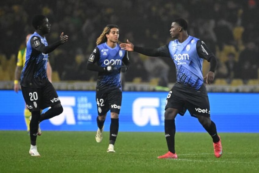 Monaco's Breel Embolo (R) celebrates his goal with teammates Kassoum Ouattara and Saimon B